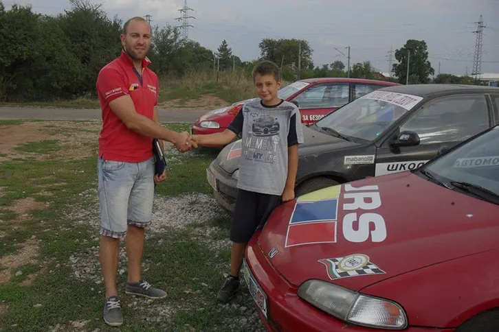 Vasil Jekov congratulating a teenager on completing the rally school programme