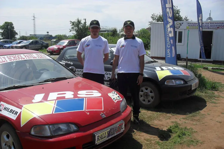 Ka Myng Roung in front of our sports cars at the rally track