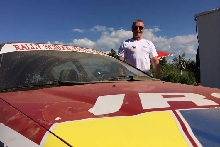 Teodor at the rally training track next to his training car